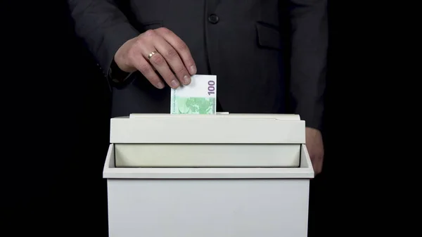 Schroeder destruye un billete de cien euros. Empresario en un traje mete dinero en una trituradora de papel — Foto de Stock