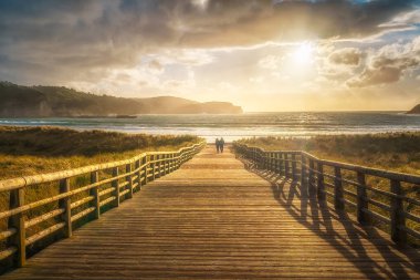 boardwalk to the beach in Gorliz clipart