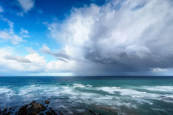 Stormy clouds and heavy rain on a sea — Stock Photo, Image