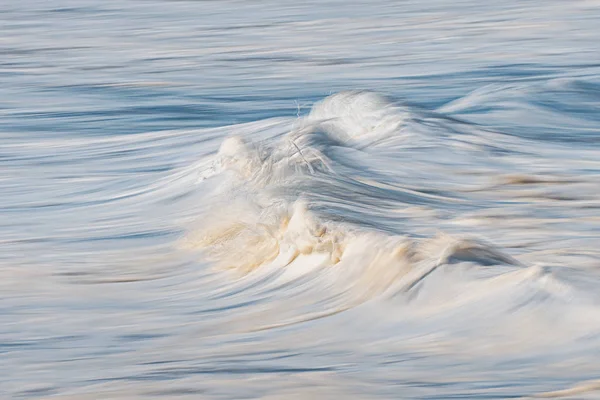 Photo of a sea foam with in camera panning technique — Stock Photo, Image
