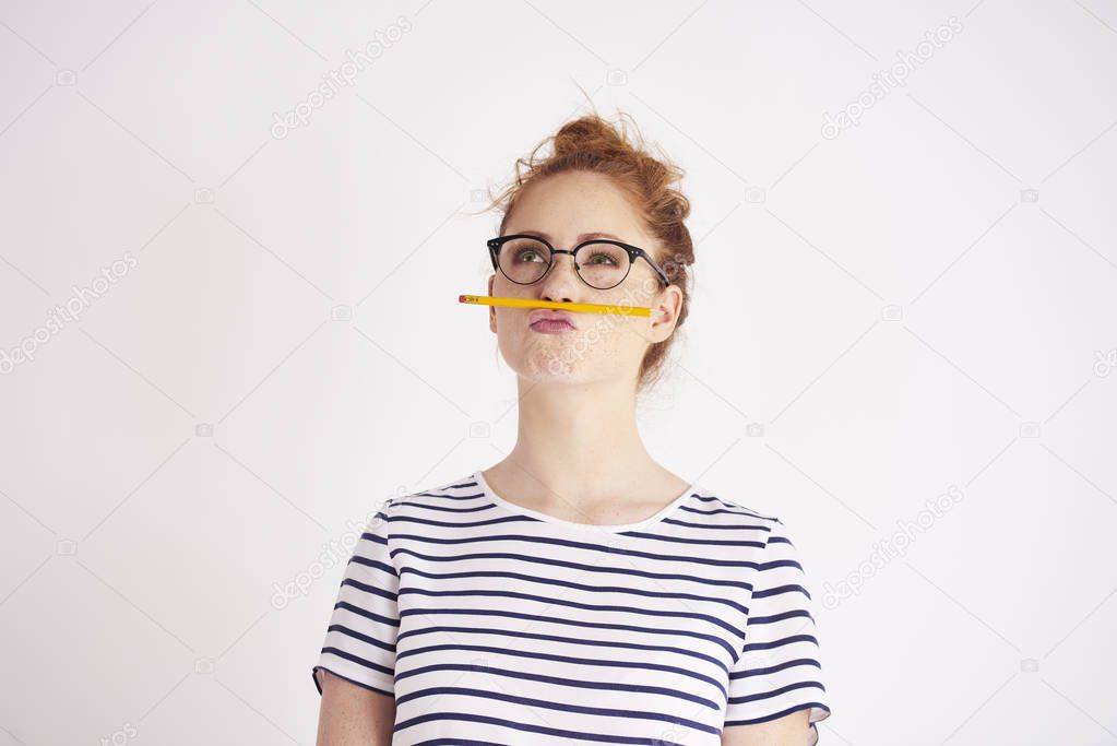 Bored woman having fun with pencil