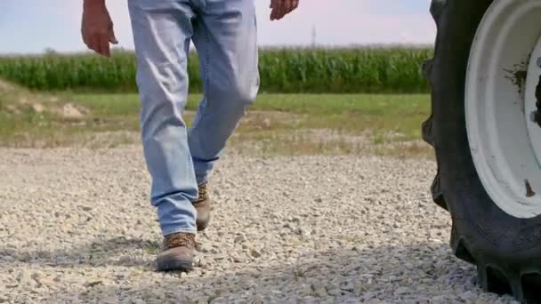 Part Farmer Entering Tractor — Stock Video