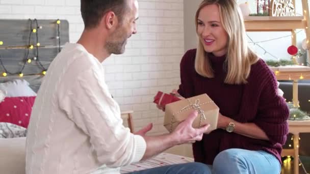 Loving Couple Exchanging Christmas Gifts Each Other — Stock Video