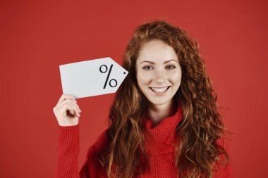 Smiling woman holding blank price tag clipart