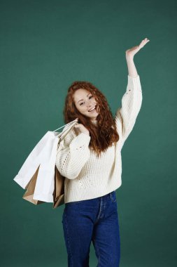 Stüdyo çekim, alışveriş torbaları ile gülümseyen kız