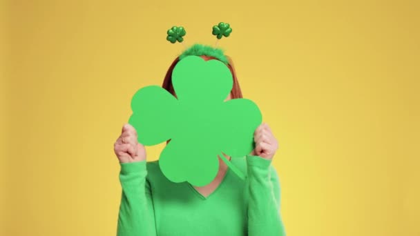 Playful Woman Holding Clover Shaped Banner Copy Space — Stock Video