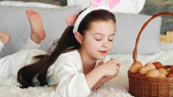 Playful Girl Putting Eggs Easter Basket — Stock Video