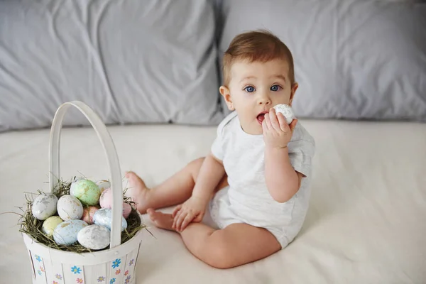 Bebé Juguetón Comiendo Huevo Pascua Cama — Foto de Stock