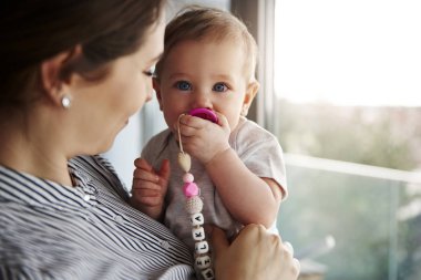 Genç anne küçük kızı taşıyan kadeh