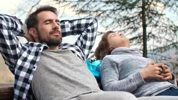 Dad His Teenage Son Closed Eyes Relaxing Outdoors — Stock Video