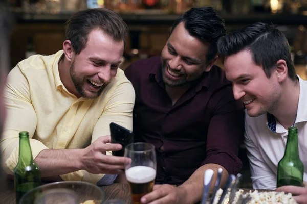 Three Men Using Mobile Phone Meeting Pub — Stock Photo, Image