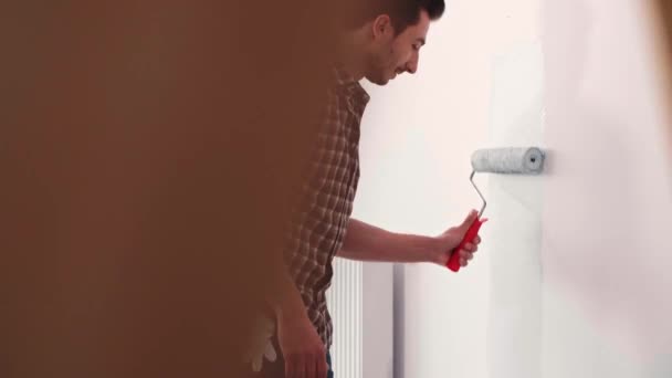 Joven Pintando Pared Interior Nuevo Apartamento — Vídeo de stock