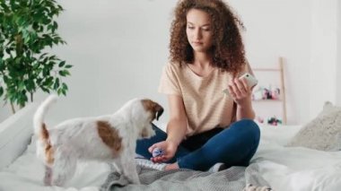 Yatakta köpeğiyle eğlenen neşeli kız 