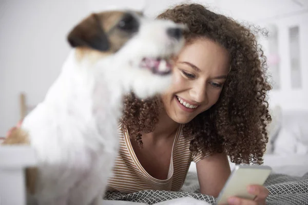 Sorrindo Adolescente Deitada Cama Usando Telefone Celular — Fotografia de Stock