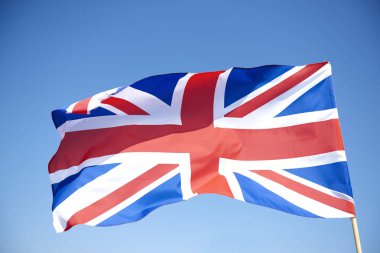 Close up of waving British flag in the sky clipart