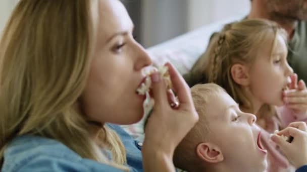 Handheld Video Shows Family Eating Popcorn Watching — Stock Video