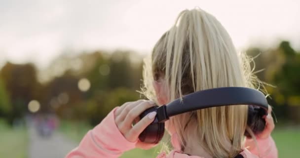 Handheld Video Shows Woman Listening Music Headphones — Stock Video
