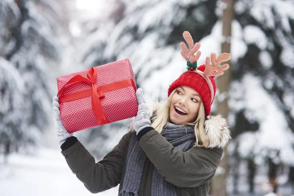 Young Woman Shaking Her Christmas Present — Stock Photo, Image