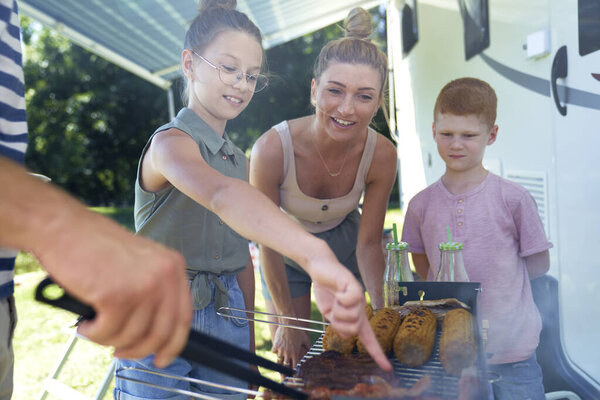                                Family waiting for the barbecue meals