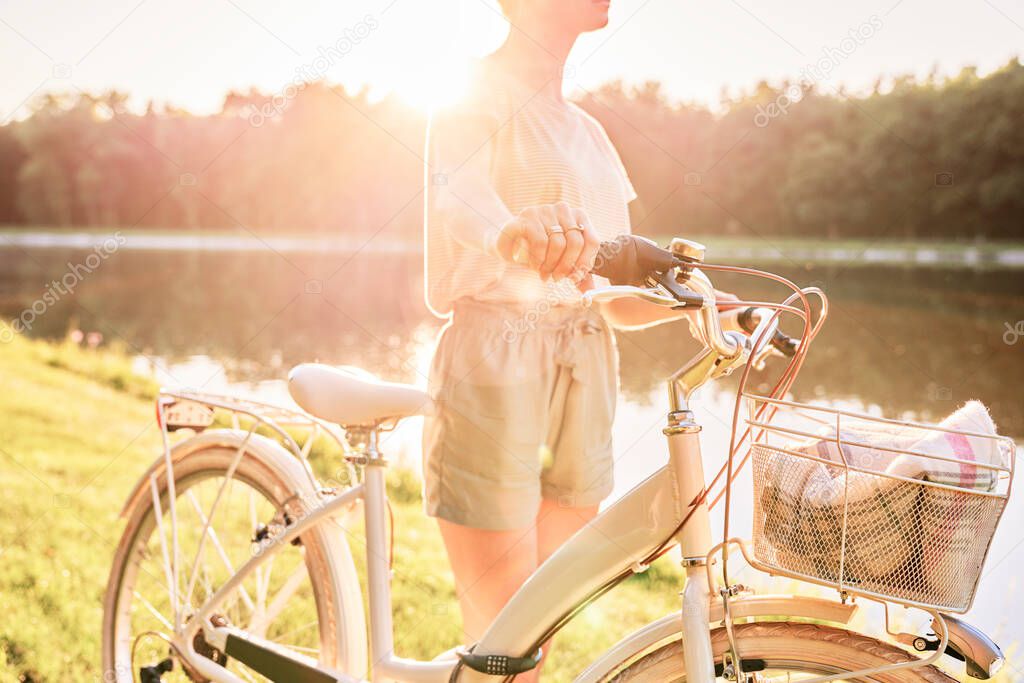 Close up of woman with bike by the lake