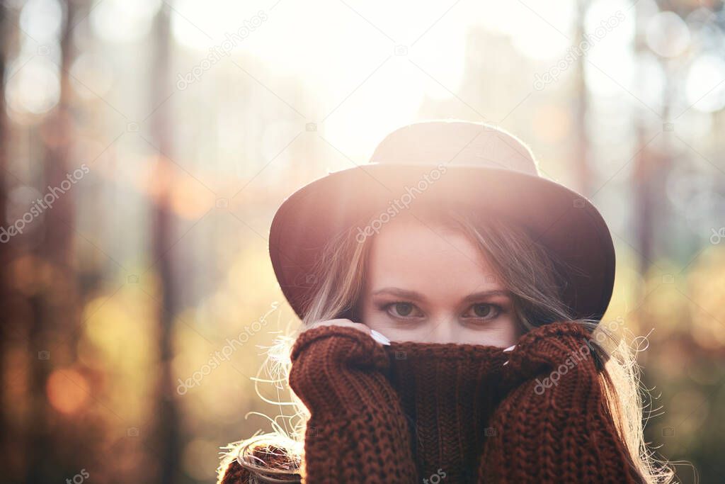 Secret woman with beautiful eyes in the autumnal forest