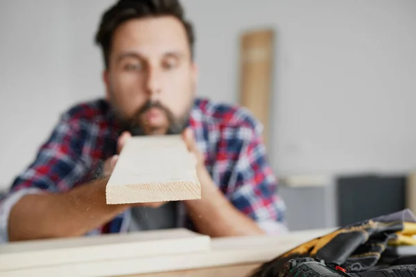 Man Blowing Dust Board — Stock Photo, Image