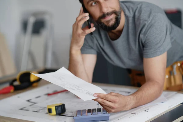 Carpenter Holding Plans Talking Phone — Stock Photo, Image