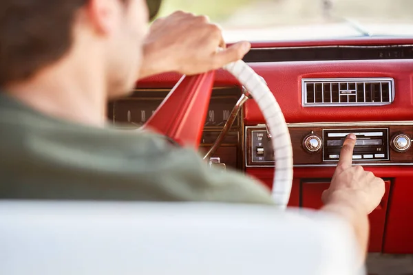 Close up of man driving an old car