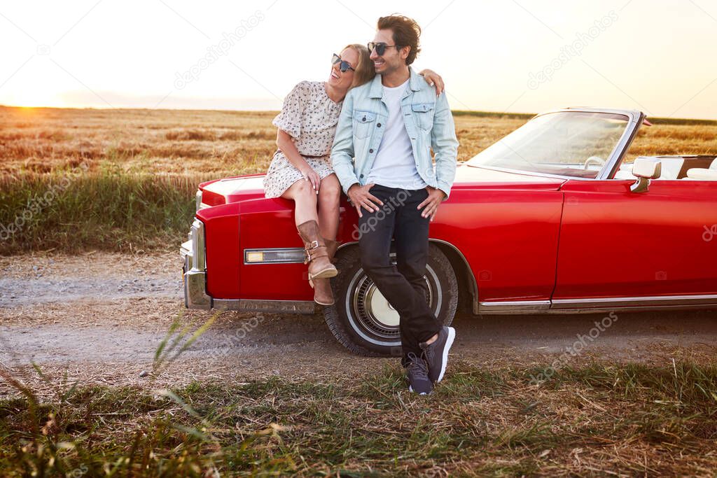 Couple on a date by the car                               