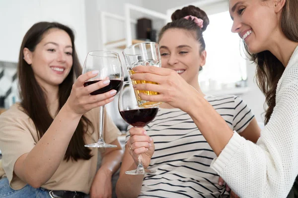 Three friends drinking and toasting wine