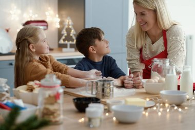 Çocuklar Noel kurabiyeleri için pasta hazırlıyorlar.
