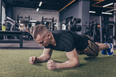 Tahta yapıyor spor fitness erkeklerde tam uzunlukta çekim spor salonunda, kopya alanı egzersiz. Atletik sağlıklı fitness adam spor stüdyoda çalışma dışarı. Belirlenmesi, çaba, sağlık kavramı