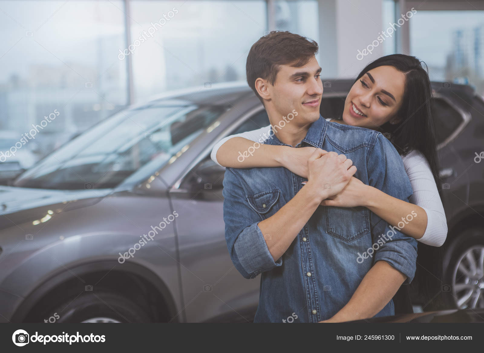 Happy Loving Young Couple Smiling Each Other Embracing Buying New
