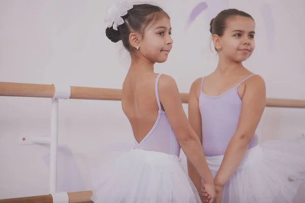 Two little ballerinas talking after dancing lesson
