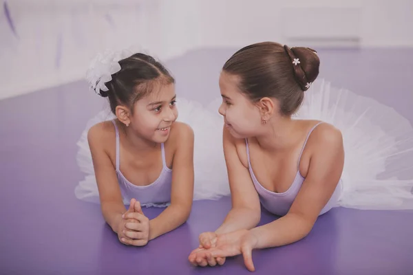 Two little ballerinas talking after dancing lesson