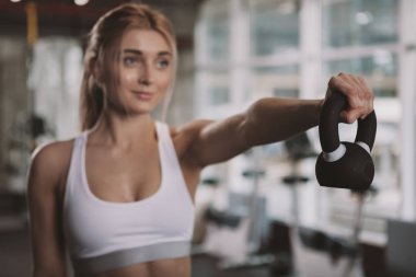 Beautiful young fitness woman working out at the gym