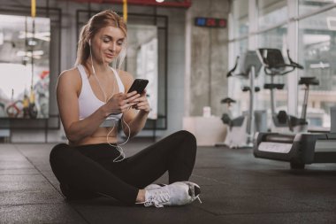 Beautiful young fitness woman working out at the gym