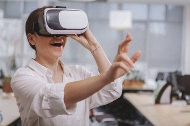 Charming young businesswoman working at her office