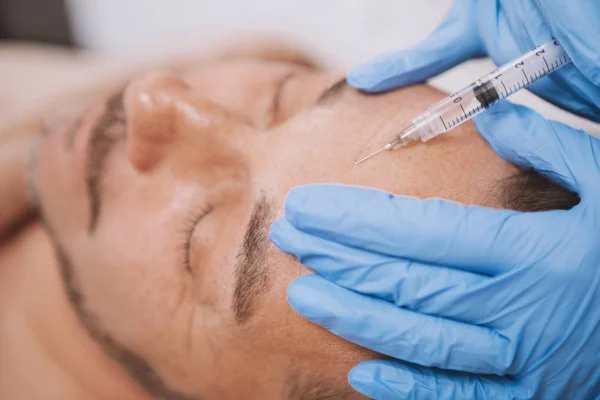 Mature man getting facial filler injections — Foto de Stock