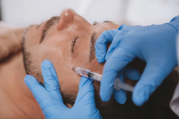 Mature man getting facial filler injections — Stockfoto