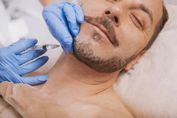 Bearded handsome mature man getting anti-wrinkle treatment — Foto de Stock