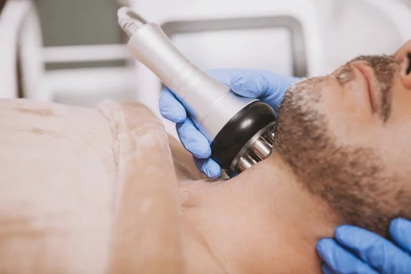 Mid-aged male client enjoying hardware cosmetology treatment — Foto de Stock