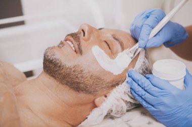 Happy mature man relaxing at spa center