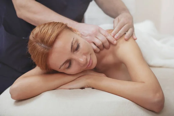 Gorgeous woman enjoying full body massage at spa center — стоковое фото
