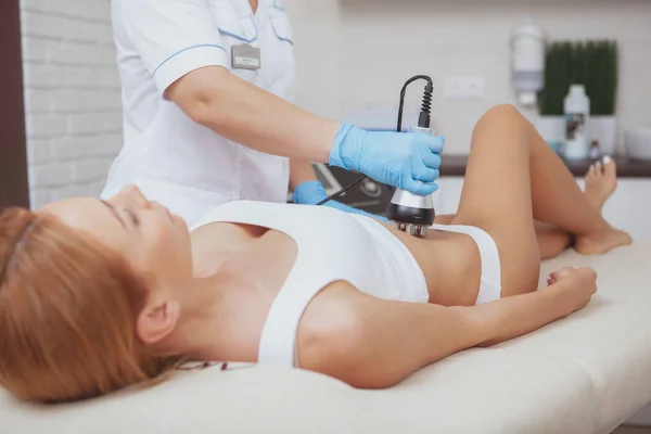 Beautiful woman getting rf-lifting treatment by cosmetologist — Zdjęcie stockowe