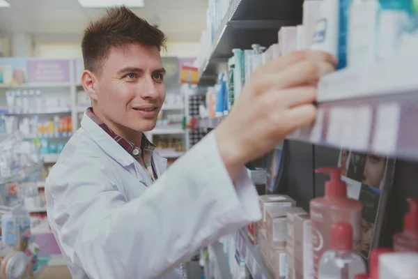 Hombre guapo farmacéutico que trabaja en su farmacia — Foto de Stock