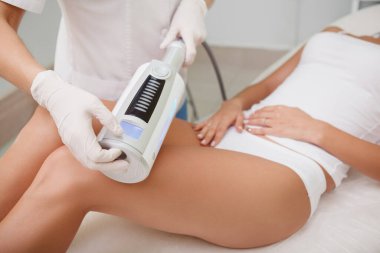 Unrecognizable woman getting  massage on her thighs