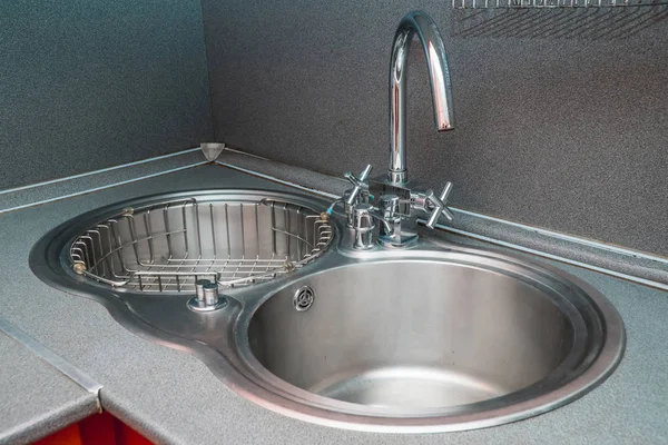 The photo of a sink in a The photo of a sink in a  kitchen — Stock Photo, Image