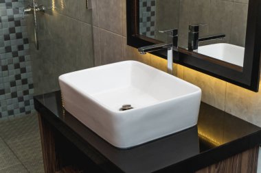 Banyoda seramik lavabo ve ayna fotoğrafı.