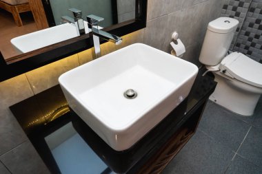 Banyoda seramik lavabo ve ayna fotoğrafı.